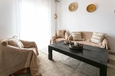 a living room with a couch and a coffee table at Le Joyau De Majorelle - Marrakech in Marrakech