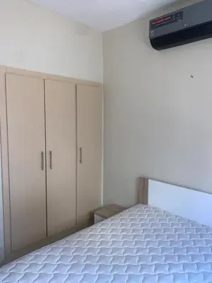 a bedroom with white cabinets and a white mattress at المنتزه الجديد in Marrakech