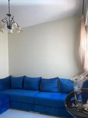 a blue couch in a living room with a table at المنتزه الجديد in Marrakech