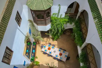 an overhead view of a patio with a table and chairs at Riad Tampacao in Marrakech