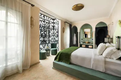 a bedroom with a bed and a large window at Riad Dar Acsameda & Spa in Marrakech