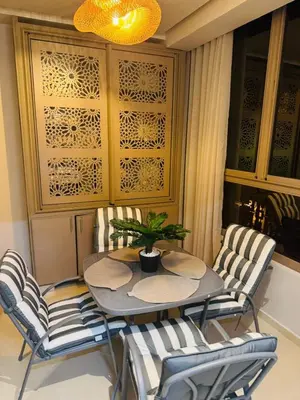 a dining room with a table and chairs at Luxury Apartment in Central Marrakech - Pool & Fast Wi-Fi in Marrakech