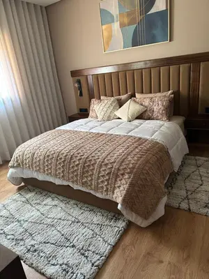 a bedroom with a large bed and a rug at Luxury Apartment in Central Marrakech - Pool & Fast Wi-Fi in Marrakech