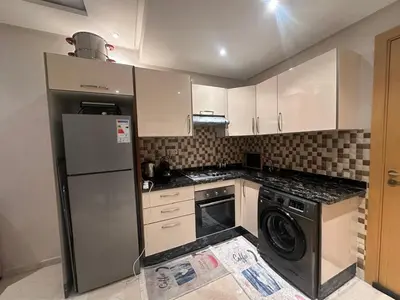 a kitchen with a refrigerator and a dishwasher at Appartement chambre et salon Perle20 Gueliz in Marrakech