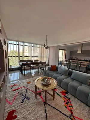 a living room with a couch and a table at Apartment Gueliz Victor Hugo in Marrakech