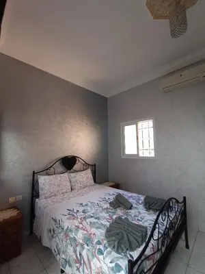 a bedroom with a bed and a window at MARRAKECh TYPICAL HOUSE MAISON TYPIQUE MARRAKECH G2 40 in Marrakech