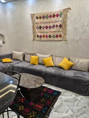 a living room with a couch and a table at El Méhénni Guéliz JACUZZI 6 Personnes Terrasse Privative in Marrakech