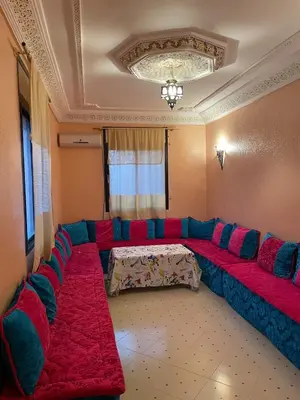 a living room with a large couch in a room at Jolie appartement à Marrakech in Marrakech
