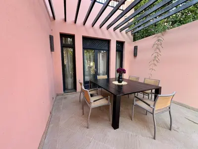 a dining room table and chairs on a patio at Riad in Hotel M Avenue in Marrakech