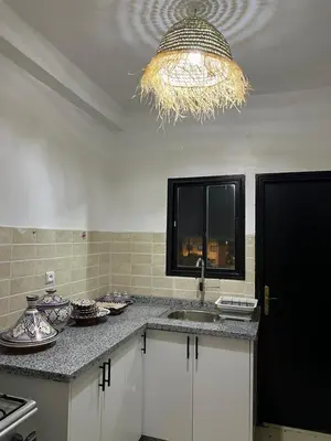 a kitchen with a sink and a chandelier at Aeroport appartement in Marrakech