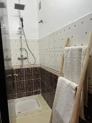 a bathroom with a shower and towels on a wall at Aeroport appartement in Marrakech