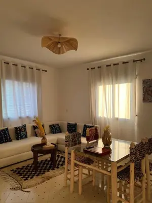 a living room with a couch and a table at Aeroport appartement in Marrakech