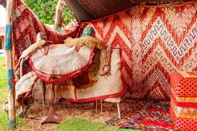a table with a blanket on it with a chair at Tente berbère in Marrakech