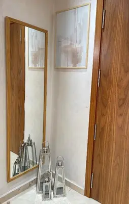 two stools are sitting in front of a mirror at Luxueux appartement a Marrakech in Marrakech