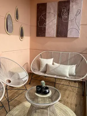 a living room with two chairs and two tables at Luxueux appartement a Marrakech in Marrakech