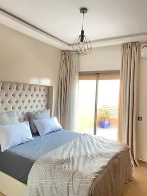 a bedroom with a large bed and a window at Kech Aliouni in Marrakech