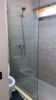 a shower with a glass door in a bathroom at Kech Aliouni in Marrakech