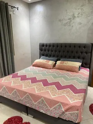 a bedroom with a large bed with pink and pink at Sunrise Private Apartment in Marrakech