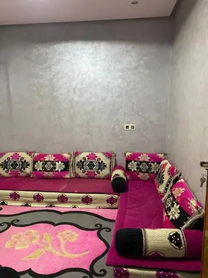 a room with a pink couch and a pink carpet at Sunrise Private Apartment in Marrakech
