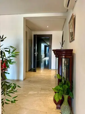 a hallway with plants and a vase on the floor at Appartement 2 chambres Atr67 Hivernage in Marrakech