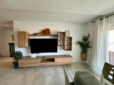 a living room with a flat screen tv on a wall at Appartement 2 chambres Atr67 Hivernage in Marrakech