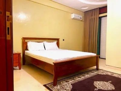 a bedroom with a large bed with white sheets at Heart of Marrakech in Marrakech