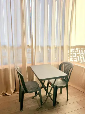 a table and two chairs in front of a window at Studio De luxe Avec BALCON in Marrakech