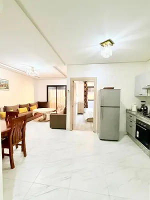 a kitchen and living room with a refrigerator at Studio De luxe Avec BALCON in Marrakech