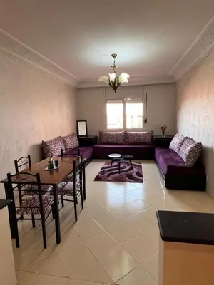 a living room with a couch and a table at Calm & Cozy Studio with Balcony in Marrakech