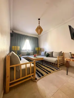 a living room with a couch and a table at A flat near the airport in Marrakech