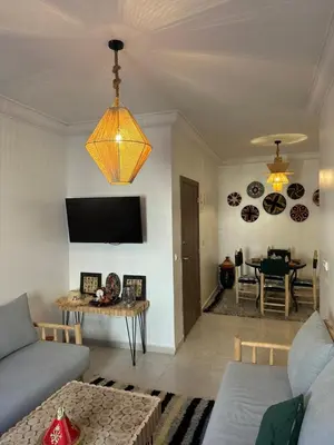 a living room with a couch and a table at A flat near the airport in Marrakech