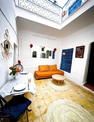 a living room with a couch and a table at Riad bleu 4 in Marrakech