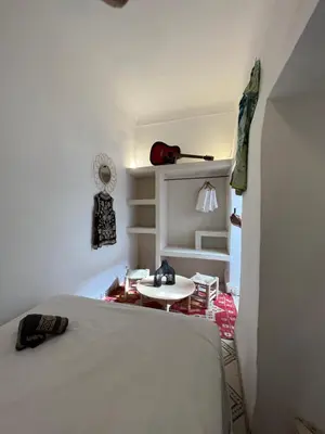 a bedroom with a bed and a small table at Riad bleu 4 in Marrakech