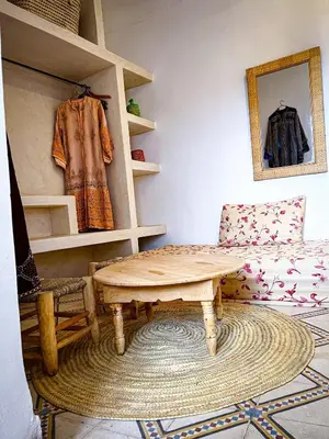 a living room with a table and a couch at Riad bleu 4 in Marrakech