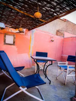 a table and two chairs and a table and chairs at Riad bleu 4 in Marrakech
