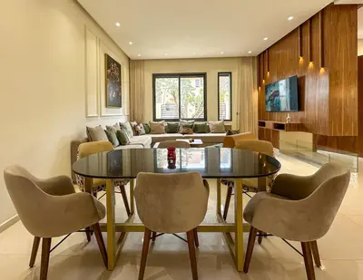 a living room with a table and chairs and a couch at Villa Stayvi 1 Heated Pool Bliss in Marrakech