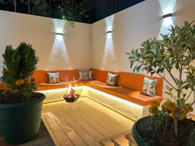 a waiting room with orange benches and potted plants at Villa Stayvi 1 Heated Pool Bliss in Marrakech