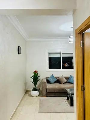 a living room with a couch and a window at Bright downtown apartment in Marrakech