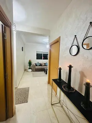 a living room with a couch and a table at Bright downtown apartment in Marrakech