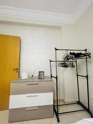 a room with a dresser and a shelf and a door at Bright downtown apartment in Marrakech