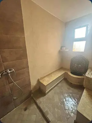 a bathroom with a shower and a toilet and a window at RIAD Marrakech zina in Marrakech