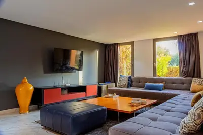 a living room with a couch and a table at Atelier Loft Oliver Palm Resort in Marrakech