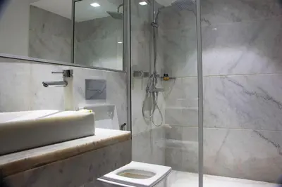 a bathroom with a shower and a toilet and a sink at Atelier Loft Oliver Palm Resort in Marrakech