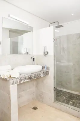 a bathroom with a sink and a shower at Lux Oasis - Marrakech Center in Marrakech