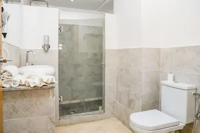 a bathroom with a toilet and a shower at Lux Oasis - Marrakech Center in Marrakech