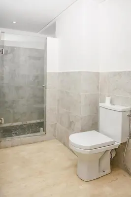 a bathroom with a toilet and a shower at Lux Oasis - Marrakech Center in Marrakech