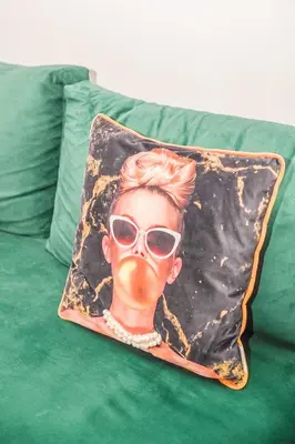 a pillow with a woman wearing a mask and sunglasses at Lux Oasis - Marrakech Center in Marrakech