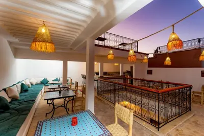 a living room with a couch and a table at Riad Abrare in Marrakech