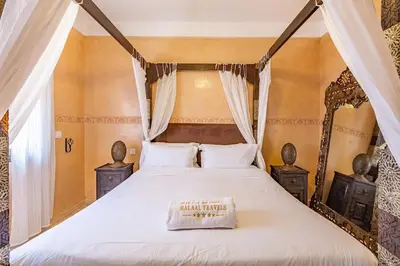 a bedroom with a large bed with a canopy at New! Apt jacaranda, wifi and parking in Marrakech