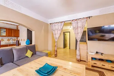 a living room with a couch and a table at New! Apt jacaranda, wifi and parking in Marrakech
